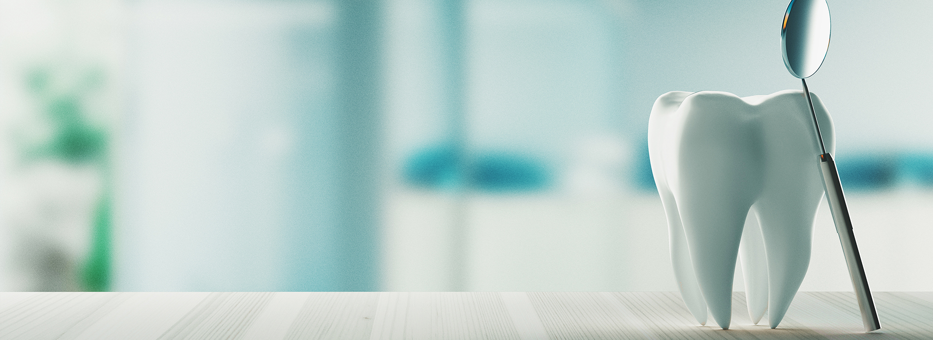 The image features a close-up view of a toothbrush with bristles placed on a white surface, which appears to be a countertop, with a blurred background that suggests an indoor setting, possibly a bathroom.